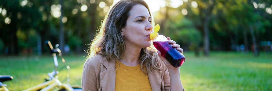 Woman drinking jabuticaba juice