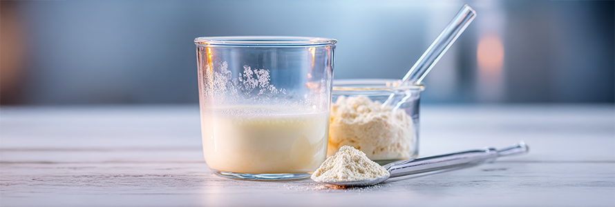 White powder supplement dissolving in a glass of water.