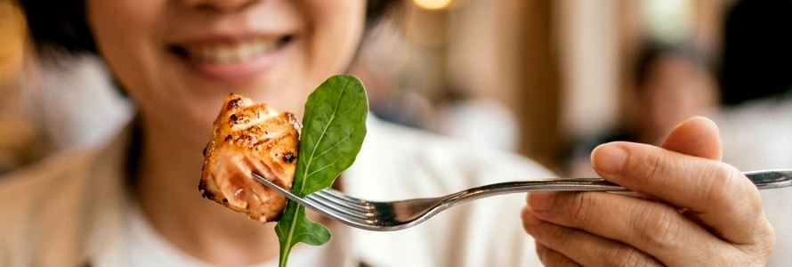 Woman eating chicken with fork